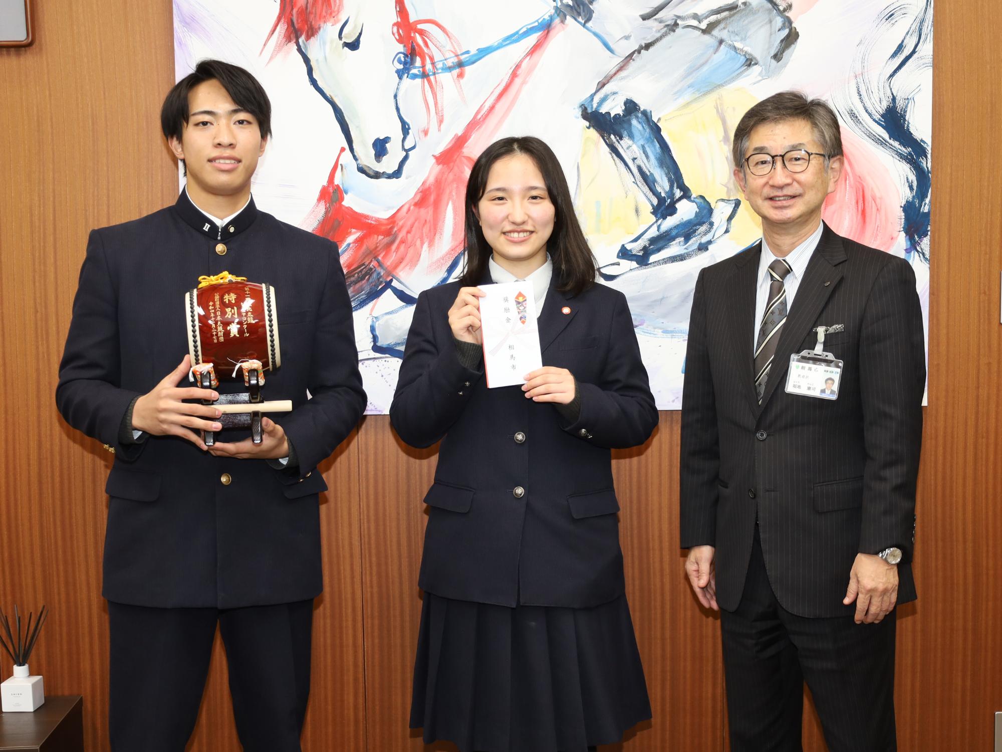 芸術文化奨励金交付式で、相馬太鼓部代表者が福地教育長に受賞を報告する様子